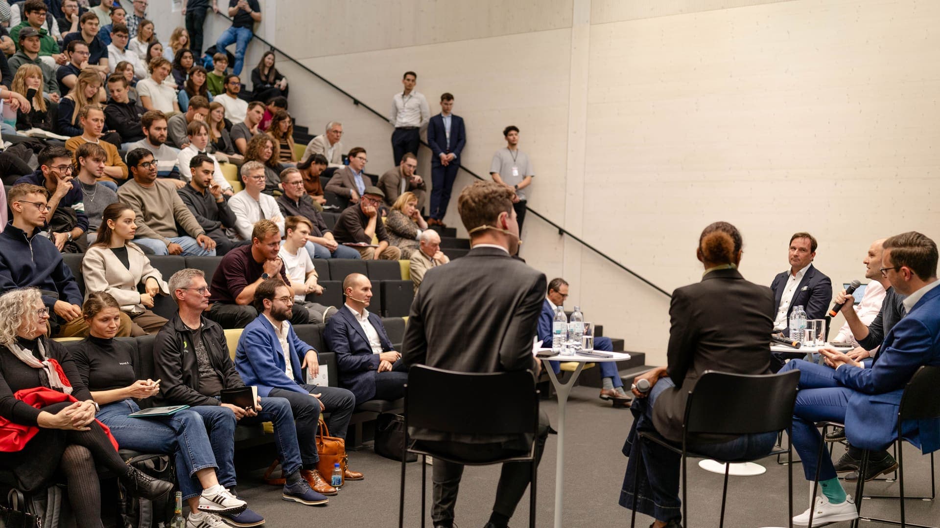 Panel speaking to a full auditorium at War for AI Talent