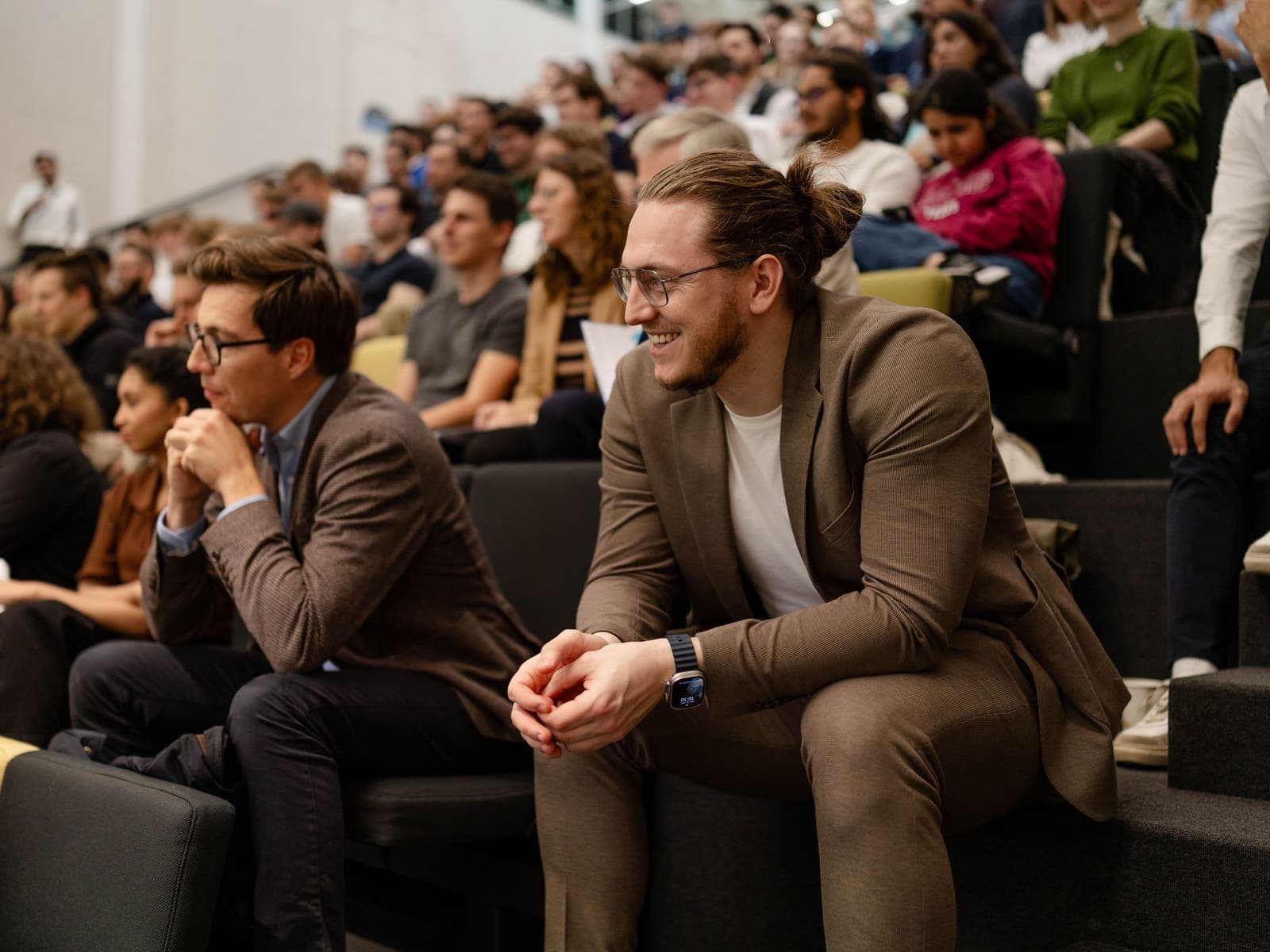 Engaged audience members in a lecture hall