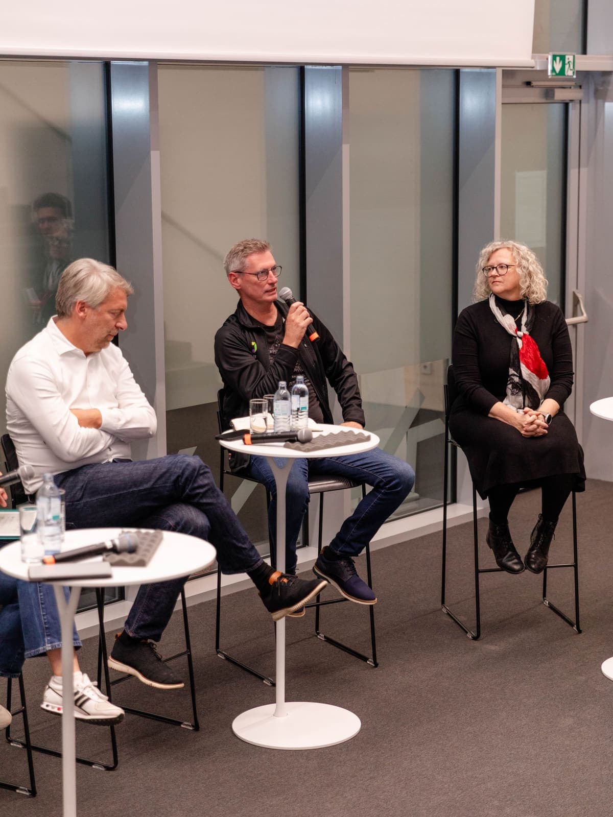 Speakers seated on stage during a panel