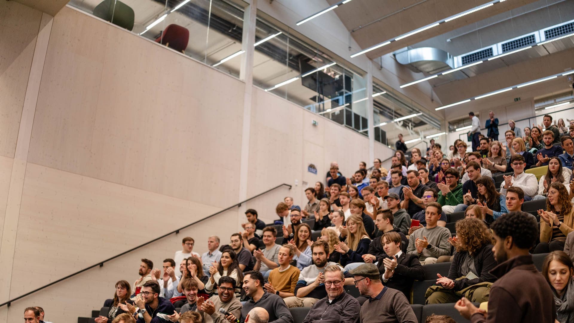 Audience applauding at a Young AI Leaders gathering