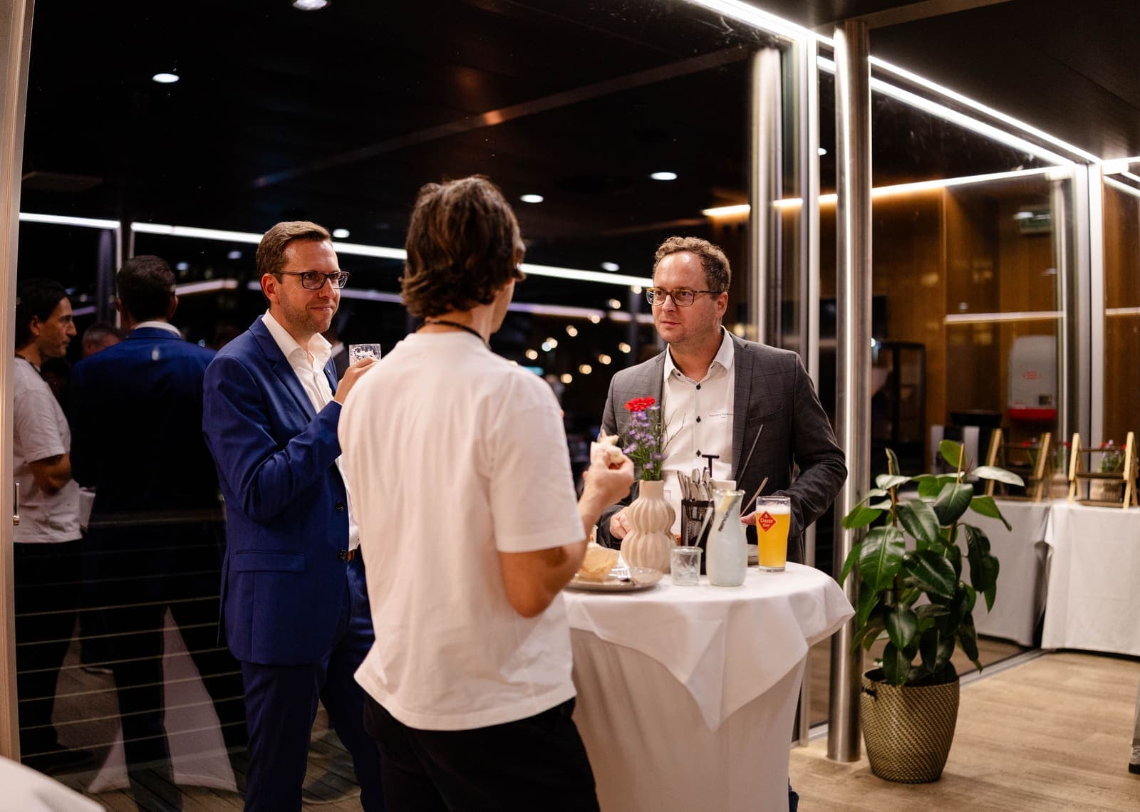 Partners discussing around a high table